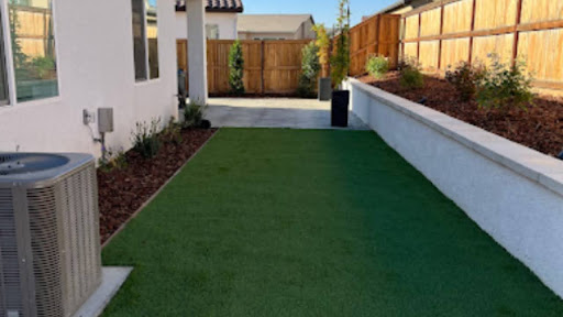 Professional landscaping with artificial turf and raised planter beds at a Madera County, CA home by Longhorn Landscapes